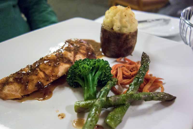 Some kind of fish, with veggies and twice baked potato.
