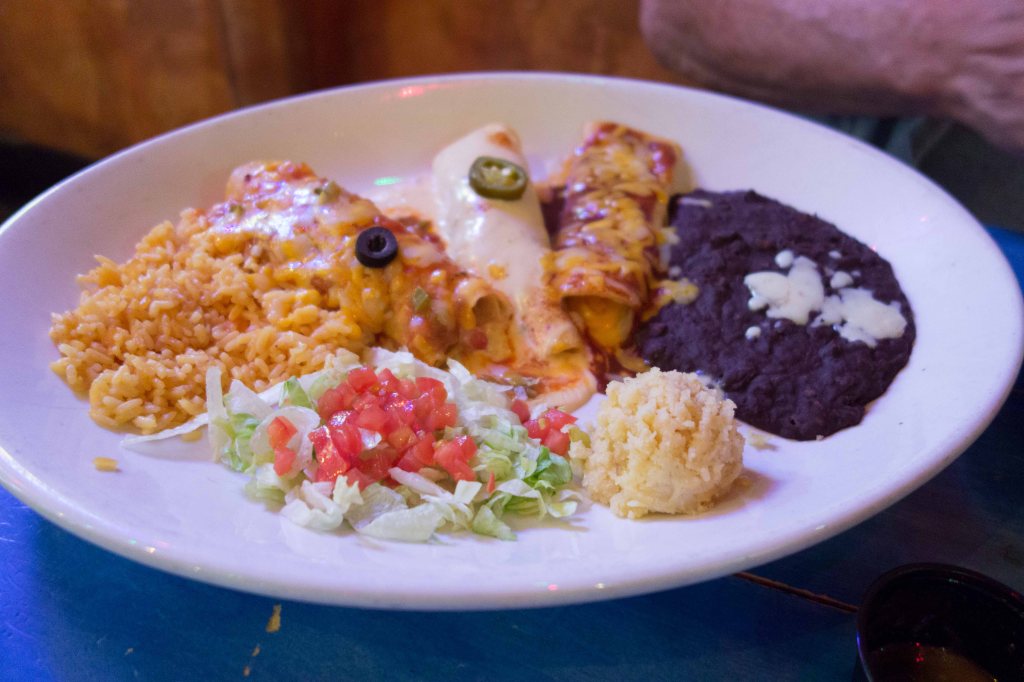 Three enchiladas.  On a plate the size of a manhole cover.