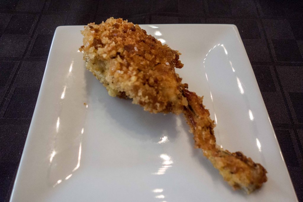 Breaded and fried frog leg.