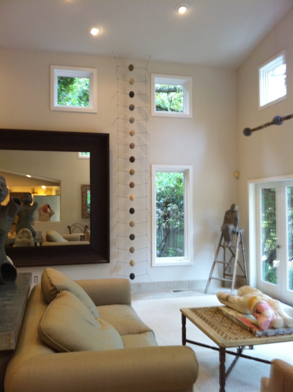 The long ladder-like item next between the mirror and the window. It is ceramic balls on a wire frame.