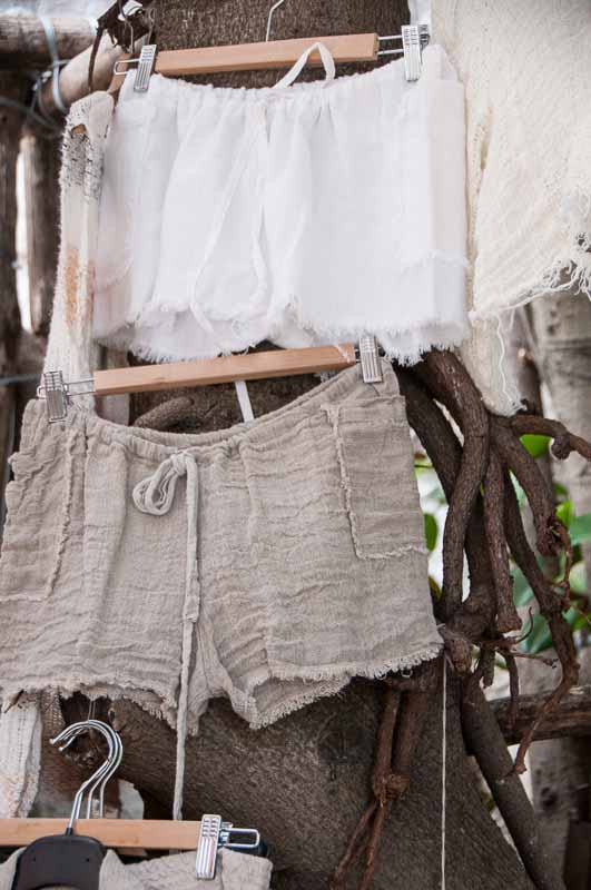 The tree trunk  enhances the natural colors and texture of the shorts