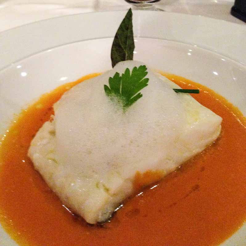 Slow cooked cod over cherry tomato with a celery infused foam