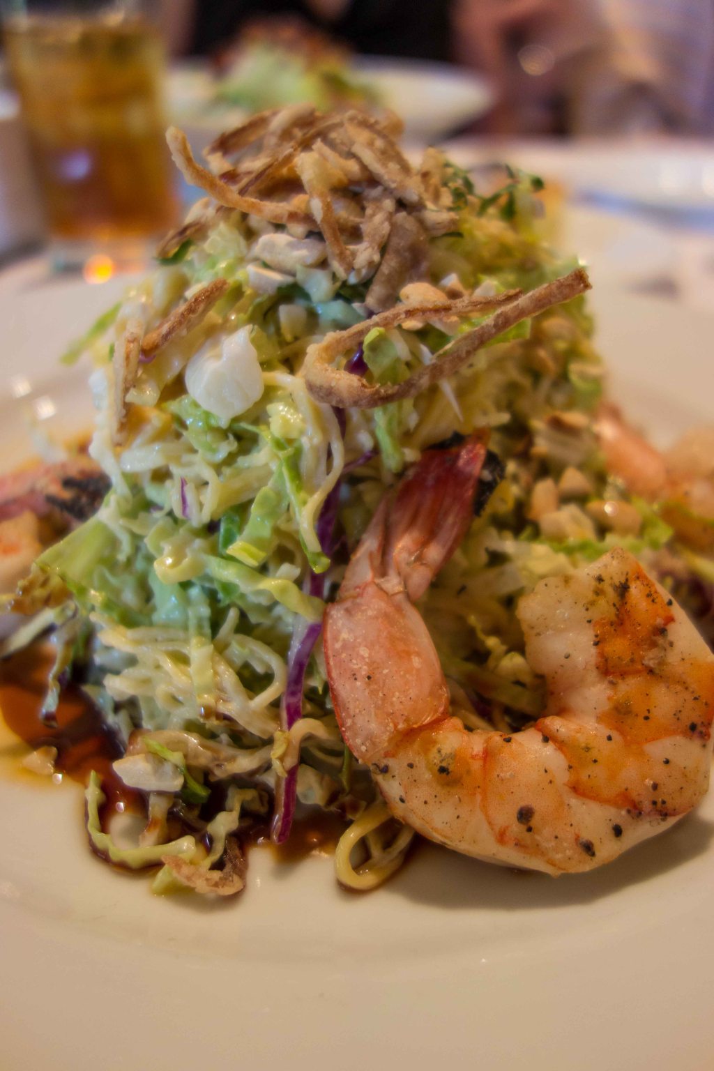 A healthy stack of cabbage and cold noodles, sesame dressing and some prawns. 