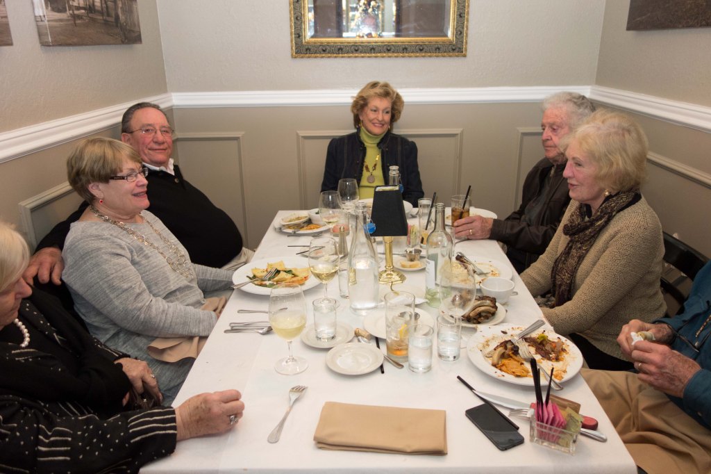 Gail, Robin Bob, Ruth, Bob, Jeannie and Bill having dinner in a phone booth.