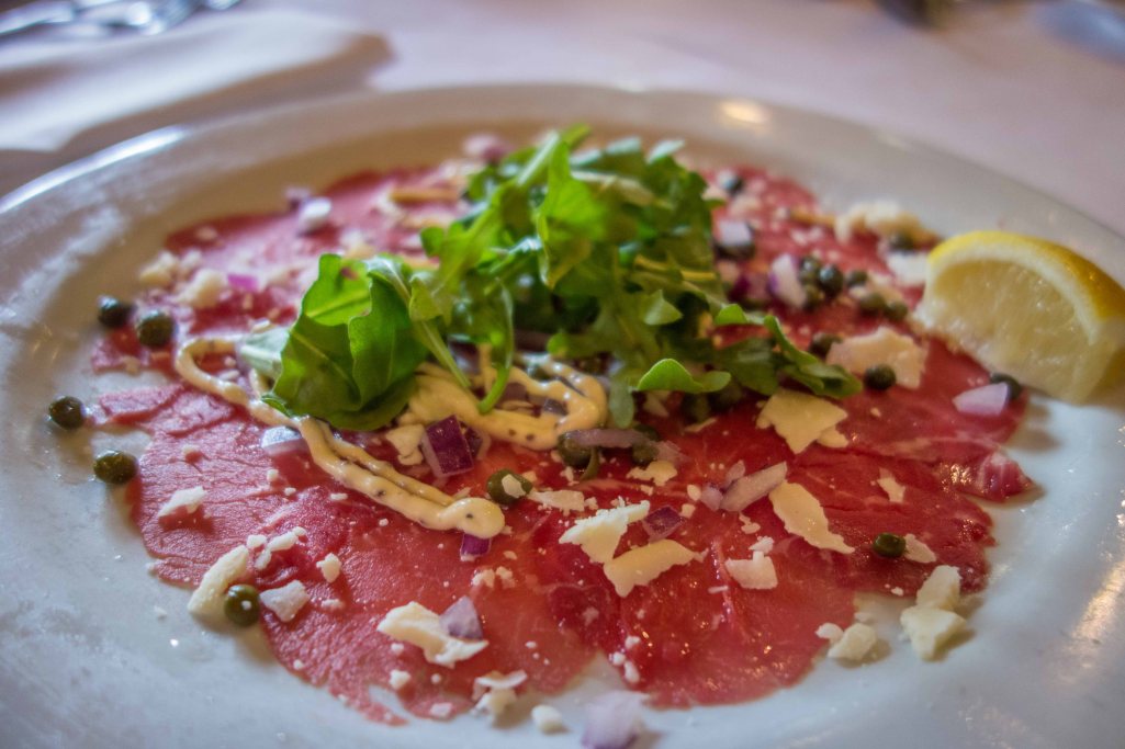 Paper thin slices of raw beef with arugula, capers, red onion and mustard sauce.