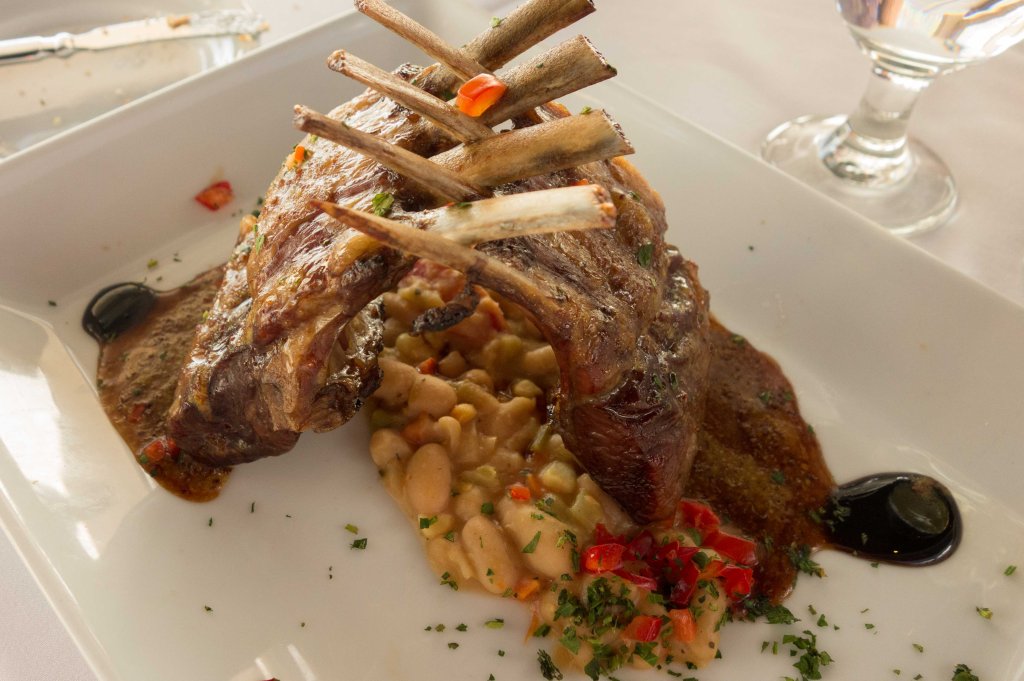 Smoked rack of lamb with bean, corn, pancetta and tomato ragout.