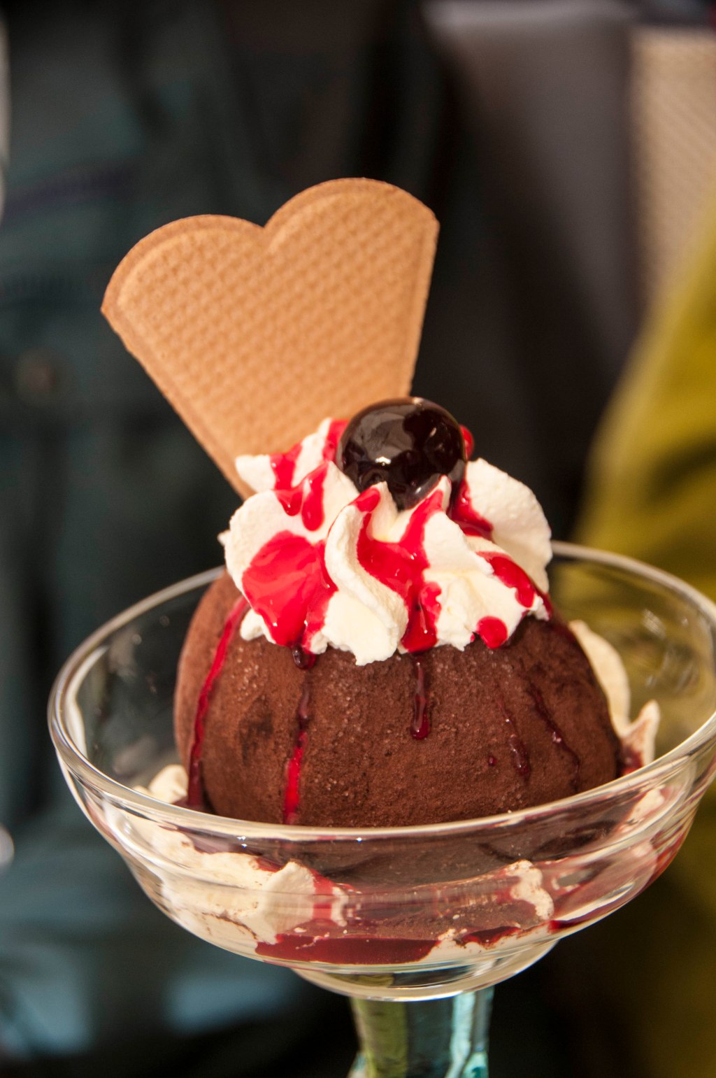 An enormous chocolate truffle, dripping with raspberry coulis.