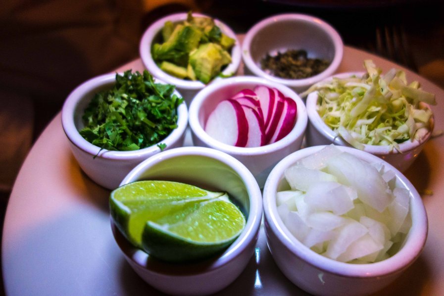 Lime, onion, radish, cabbage, avocado, oregano and cilantro.