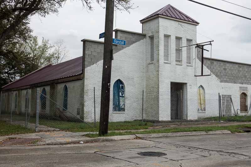Boarded windows and chain link fence