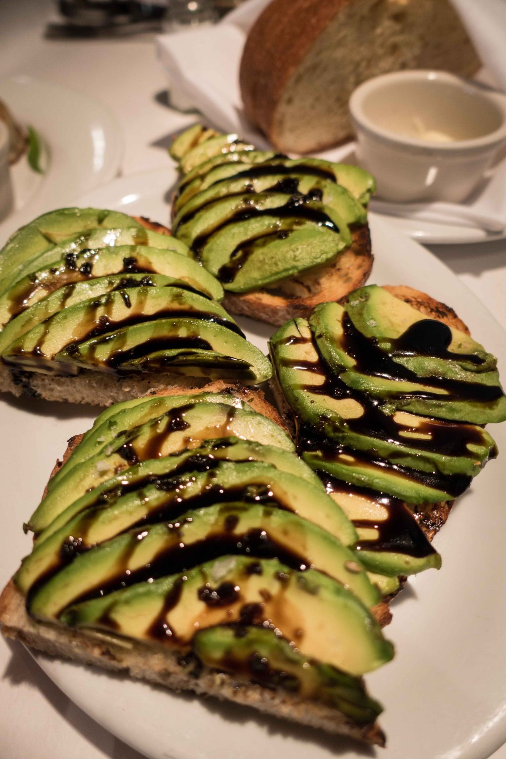 Sliced ripe avocado on toast with balsamic reduction.  Very close to a meal all by itself.