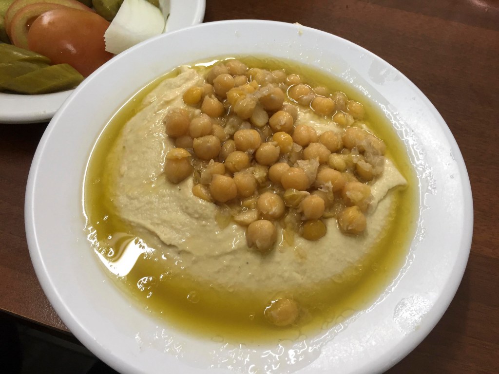 Hummus with chickpeas, swimming in olive oil.