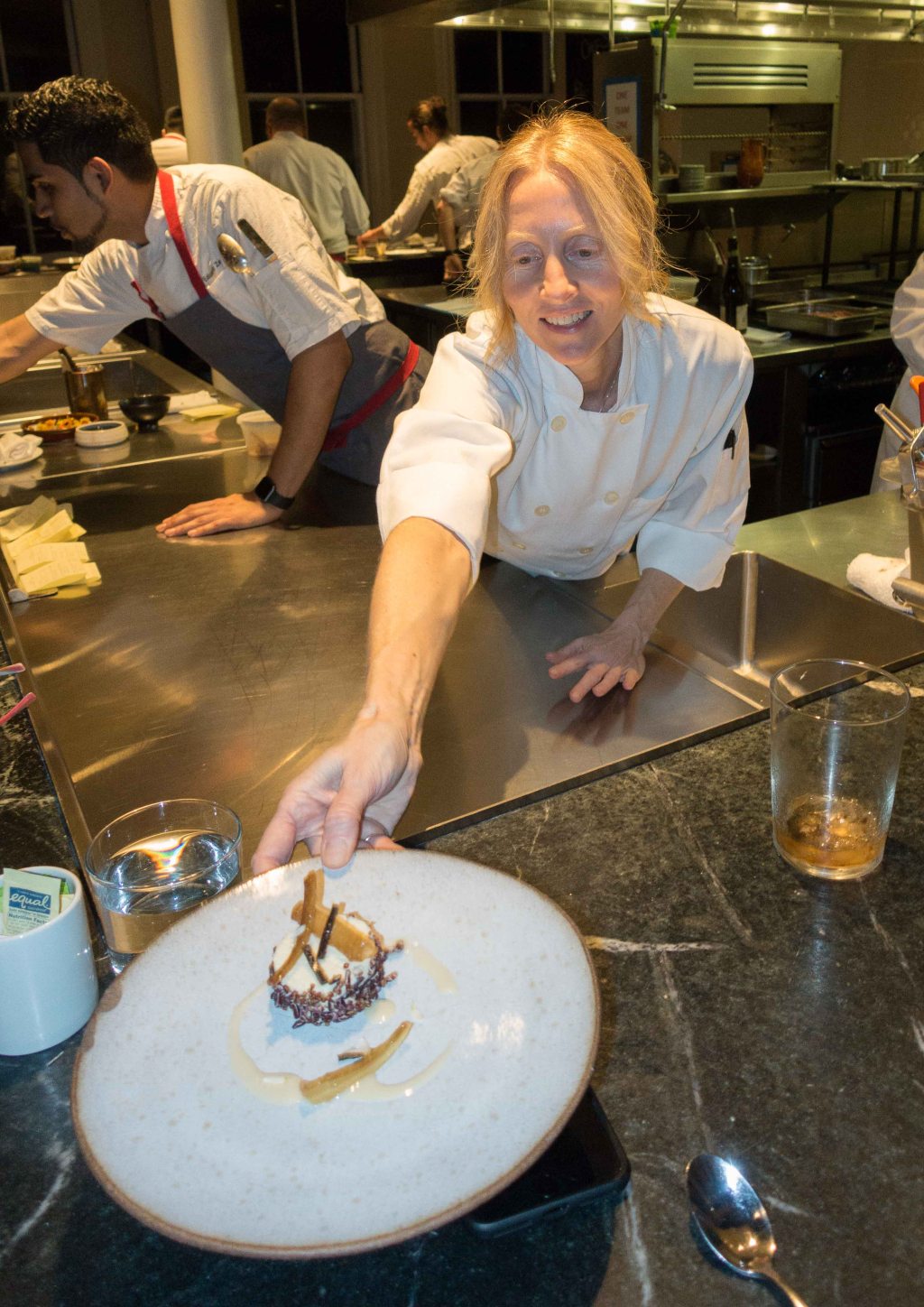 Chef Kristi Gauslow serving the dish.